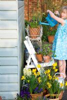 Girl watering spring containers