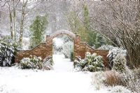 Brick arch and snow in the garden at Honeybrook House Cottage, Worcestershire