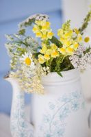 Wild flowers in antique tea pot.    Leucanthemum vulgare - Daisy, Anthriscus - Cow parsley, Sambucus - Elder and achillea
