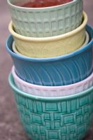 Stack of vintage flower pots in different colors