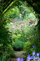 View of the Secret Garden through the rose tunnel