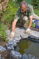 Garden pond project - step by step - adding gravel between liner and edging stones