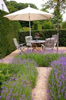 Mediterranean style garden with seating area and Lavandula angustifolia - Lavender