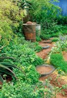 'Garden Africa' designed by Allan Capper and Ross Allan with compost bins made form oil drums. RHS Chelsea Flower Show 2006
 