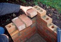 Building a barbeque. Step 7 of 11. On the side walls add bricks side on to provide support for the barbeque tray