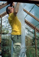 Greenhouse protection. Hanging horticultural fleece