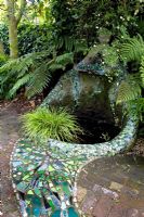 Gaudi inspired, mosaic tiled water feature in shaded area, planted with ferns and grasses. No. 11, Christchurch, New Zealand