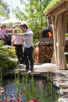 Jamie Oliver cooking. Clay oven next to a plunge pool and covered seating area with green roof. The Children's Society garden, Gold medal winner, RHS Chelsea Flower Show 2010 
 