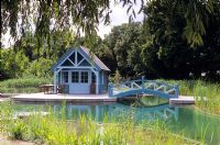 Natural swimming pool which is rain water fed, water lilies, reed filter beds, decking, bridge and gazebo 