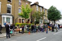 People at plant sale in an urban street, Hackney, London, UK