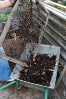Making compost - tipping unrotted materials into wheelbarrow