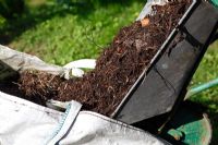 Making compost - Tipping unrotted materials into builders bag for conversion to compost