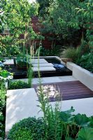 Sunken seating area, surrounded by Prunus serrula and green foliage plants. 'Urban Serenity' - Gold Medal Winner - RHS Hampton Court Flower Show 2010 