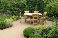 Patio with wooden furniture - 'The Combat Stress Therapeutic Garden', Silver medal winner, RHS Hampton Court Flower Show 2010 
 