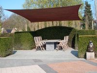 Seating area under canopy bordered by clipped Taxus - Yew hedge. Netherlands