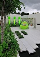 Illuminated planters with tulip sculptures in a low maintenance contemporary garden - RHS Tatton park Flower show 2010