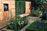 Red cedar wood wall with folding seat and yew tree backdrop in formal garden - RHS Tatton Park Flower Show 2010