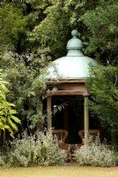 Secluded ornate summerhouse or temple at Docwra's Manor Garden. The garden opens for The National Garden Scheme 