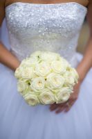 Bride holding a bouquet of white Roses 
