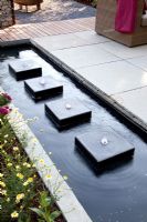Modern rectangular pond with row of square water features