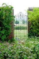 Garden gate in wall with vista beyond. Dawn End Lodge NGS, May 
 