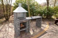 Barbeque made of gabions on patio - Appeltern garden, Holland 
