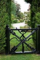 Metal garden gate made from old gardneing tools