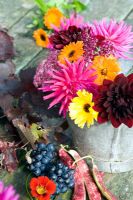 Autumn floral arrangement with Dahlias, Nasturiums, vine foliage and grapes