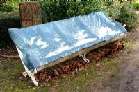 Garden furniture winter protection - Garden seat covered with taurpaulin, with terracotta pots underneath, November