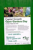 Poster, pined to an old green door, advertising Capital Growth Open Garden Day at the Srik Garden Kings Cross London UK