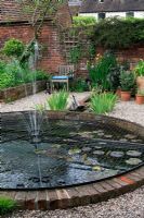 Circular brick edged pond covered with a wire mesh welded to a circular steel frame to prevent children and pets falling in.The Antiquary, Bewdley