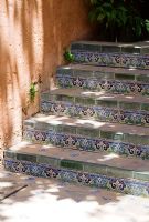 Decorative painted tiles edging steps in a mediterranean garden