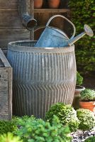 Galvanised watering can and water butt