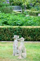 Rosalie Fiennes garden in Somerset with stone statues of dogs