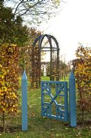 Painted gate leading to gazebo - Silverstone Farm, Norfolk