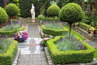 Secluded parterre garden with paths and walls made of small reclaimed cobbles, station platform tiles and bricks, parterre with Buxus sempervirens - Box hedges, Lavandula angustifolia 'Hidcote' and Thuja topiary standards and classical statue - Brocklebank Road, Southport, Lancashire NGS 
