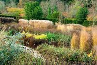 The Square Garden, full of late perennials and grasses. RHS Garden Rosemoor, Great Torrington, Devon, UK