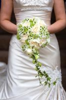 Bride holding a wedding bouquet with Roses, Ornithogalum, Ivy and Lilies