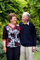 Sandra Muckle and her husband Ivan at Millisle garden, in front of mop-top Robinias
