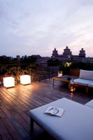 Cube lighting with sofas and decking at dusk on Terrace in Ferrara, Italy