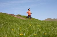 Boy running down a hill 