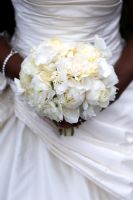 Bride holding a bouquet of white flowers including peony