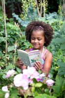 Young girl reading wildflowers book