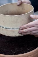 Covering seeds with soil