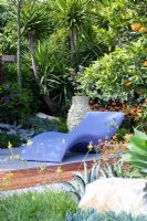 Modern recliner in contemporary Mediterranean style garden 