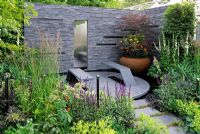 Urban garden with solar panels fitted in slate wall