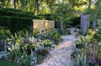 Extensive Perennial planting with water feature and reclaimed Cotswold stone Path