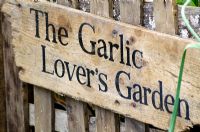 Wooden sign in the 'Garlic Lover's Garden', the Garlic Farm - RHS Hampton Court Flower Show 2011