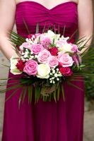 Bridesmaid holding a wedding bouquet of pink and white roses