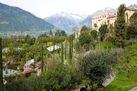 The Botanical gardens of Trauttmansdorff Castle in Merano, Italy with the castle in the background.